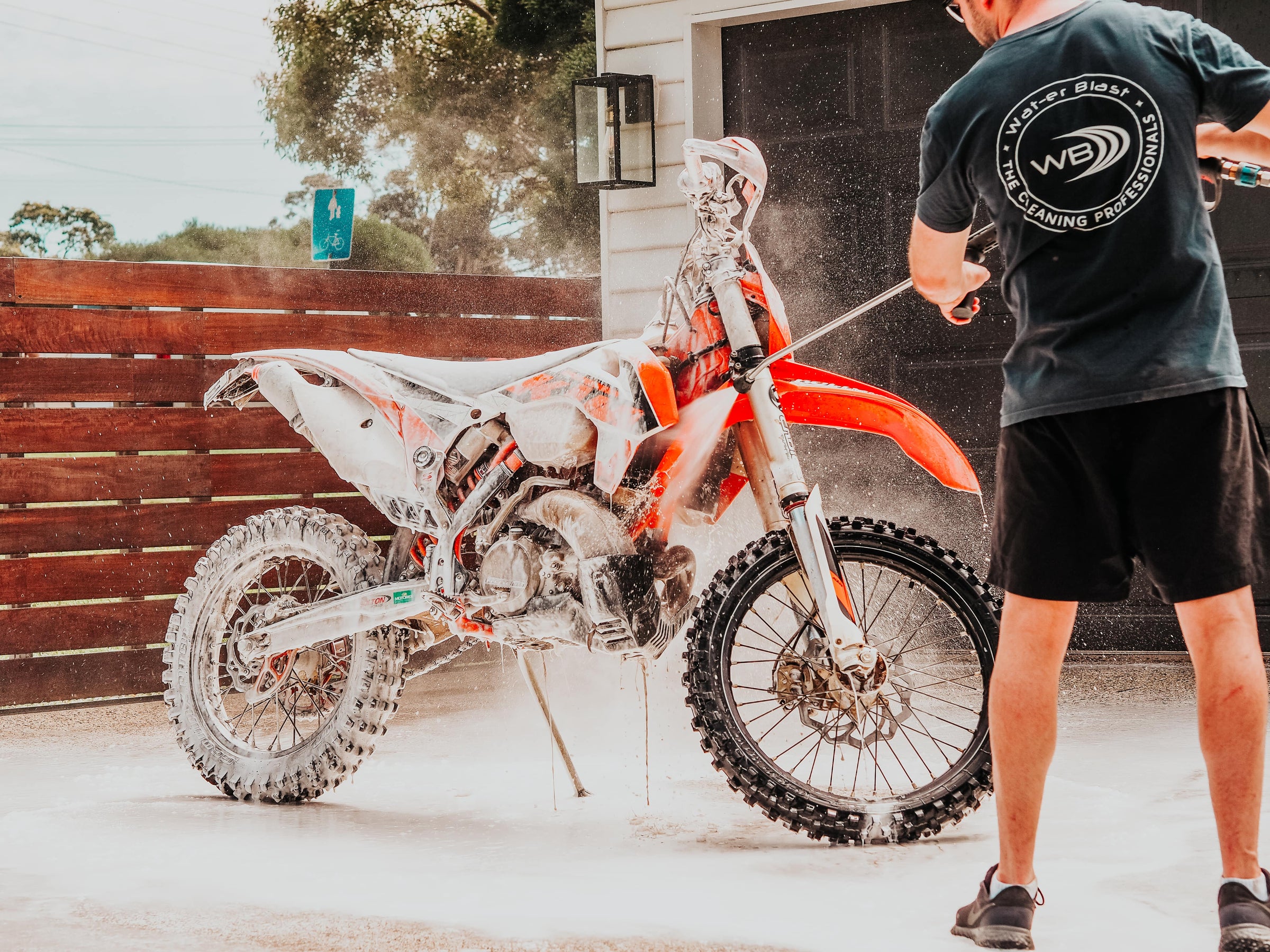 Spraying Foam on Orange Dirt Bike