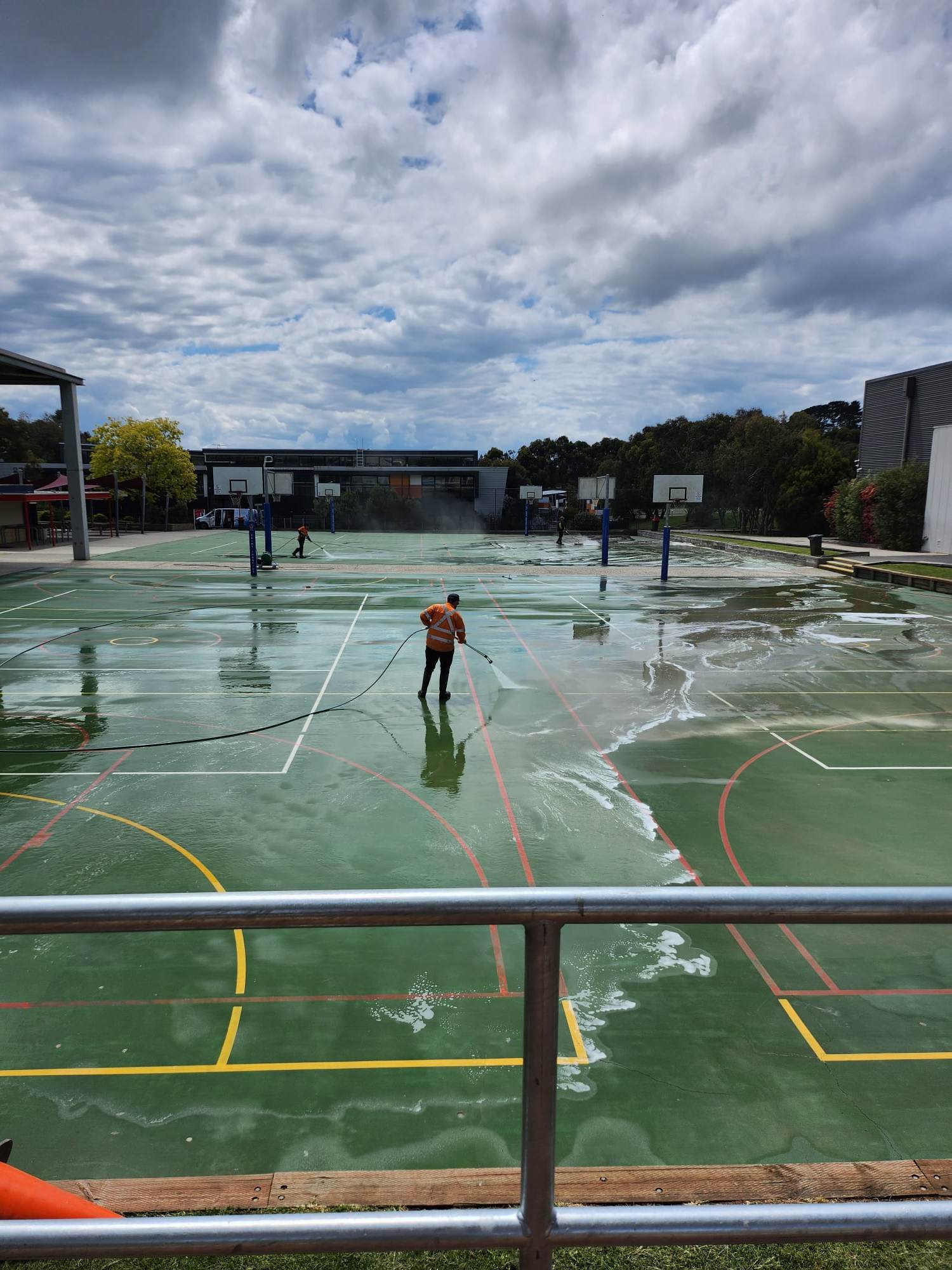 Technician High Pressure Cleaning Green School Sport Courts