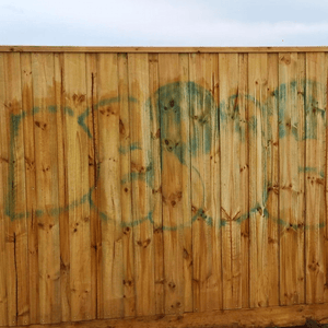 Blue Graffiti Removed from Wooden Fence 