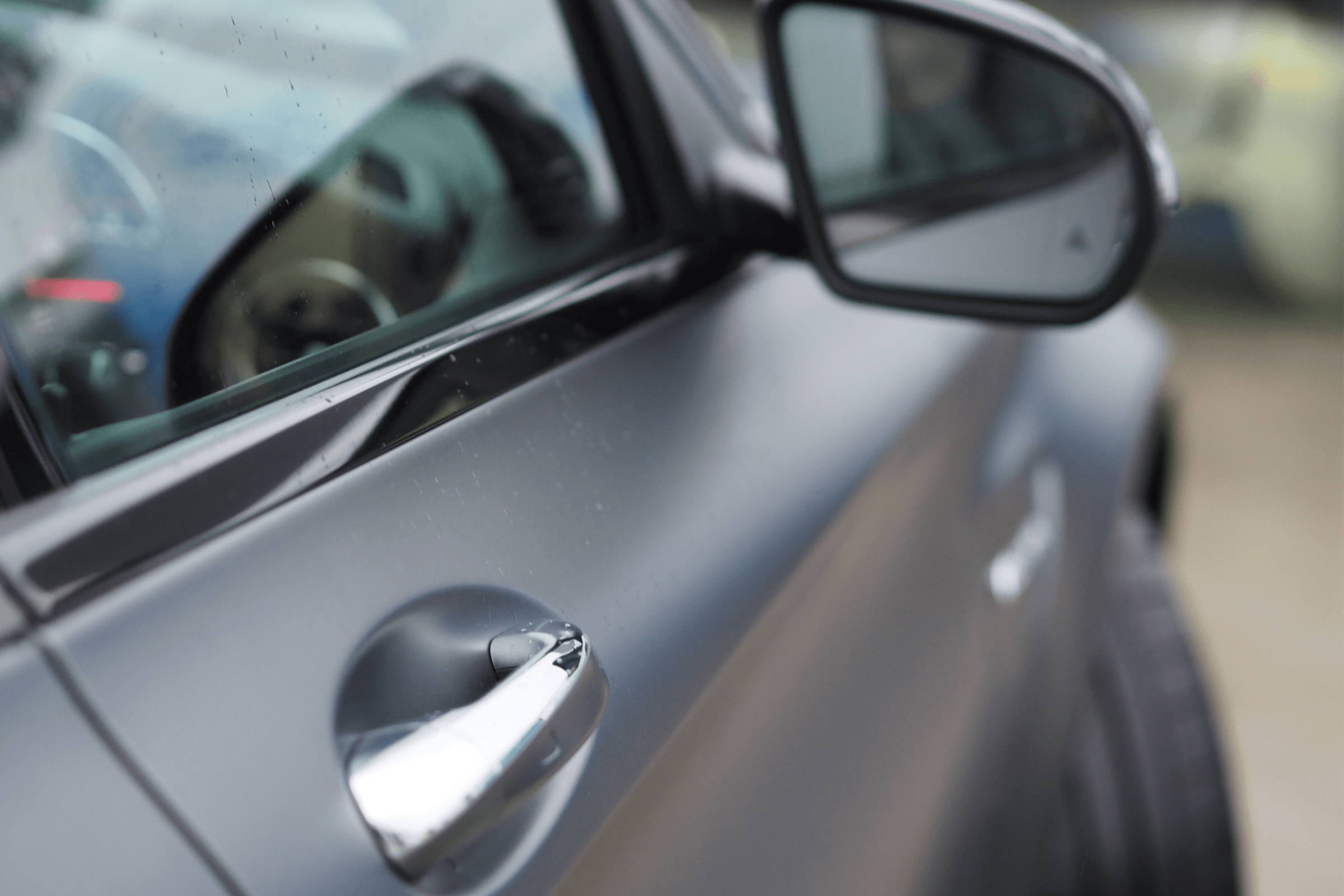 Close Up of Grey Mercedes Door Handle and Window 