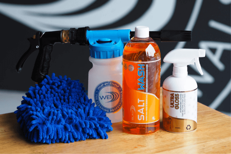 Snow Foaming Applicator with 1L 'Salt Off' Mandarin Scented Boat Wash, a 500ml Bottle of Ultra Gloss and a blue Microfibre Wash Mitt In Front of the Wat-er Blast Logo