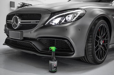 Kenotek 'Anti Insect' in a Black Spray Bottle with a Green Lid in Front of a Grey Mercedes Car