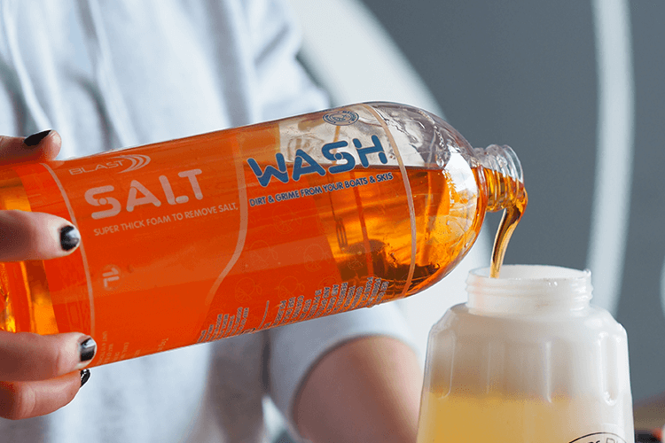 Bottle of Orange, Mandarin Scented Salt Off Boat Wash Being Poured into a Snow Foaming Blaster Gun