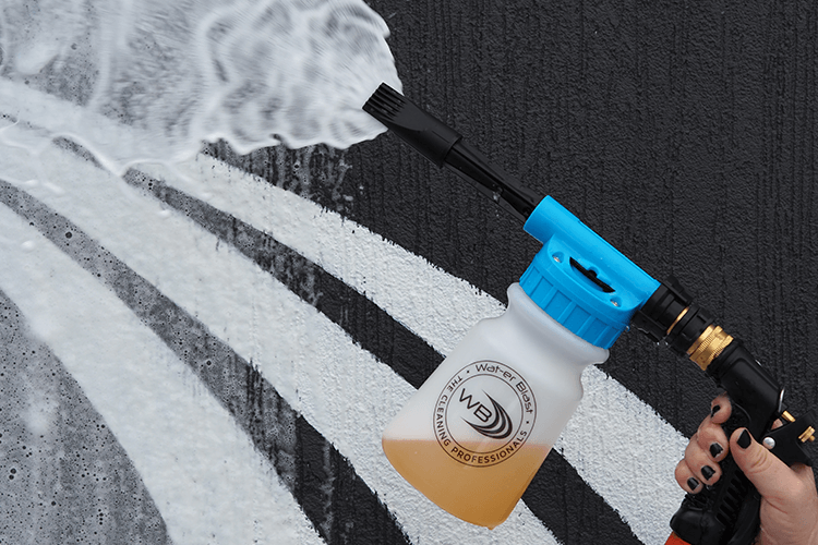 Snow Foaming Applicator with 1L 'Salt Off' Mandarin Scented Boat Wash being sprayed in front of the Wat-er Blast Logo